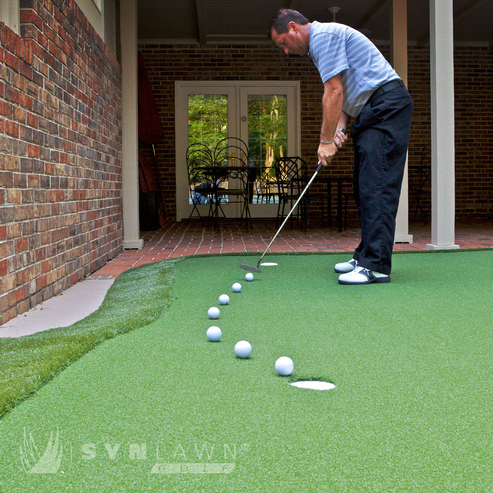 image of man putting on a Dave Pelz GreenMaker putting green